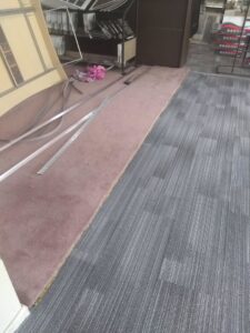 A seamless transition between two styles of carpet tiles in a commercial space, installed by Carpet Center in Nashua, NH.