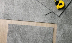 Carpet tiles and a tape measure laid out for installation by Duke Brothers Oriental Rug Cleaning in Norfolk, VA.