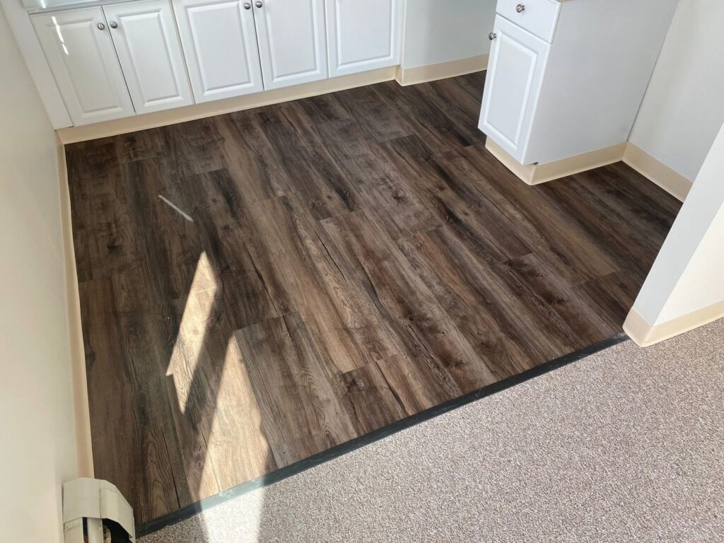 A seamless transition from carpet to laminate flooring installed by Essex Companies LLC in Salem, NH.