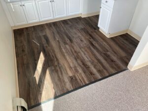 A seamless transition from carpet to laminate flooring installed by Essex Companies LLC in Salem, NH.