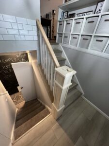 Carpet treads installed on a wooden staircase by Modern Flooring & Renovations WNY in Tonawanda, NY.