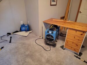 Carpet lifted with drying equipment for water damage restoration by My Carpet Cleaning & Restoration Services in Silver Spring, MD.
