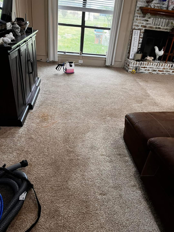 A carpet showing visible stains and cleaning equipment before a job by SAENZ Carpet Cleaning in Dallas, TX.