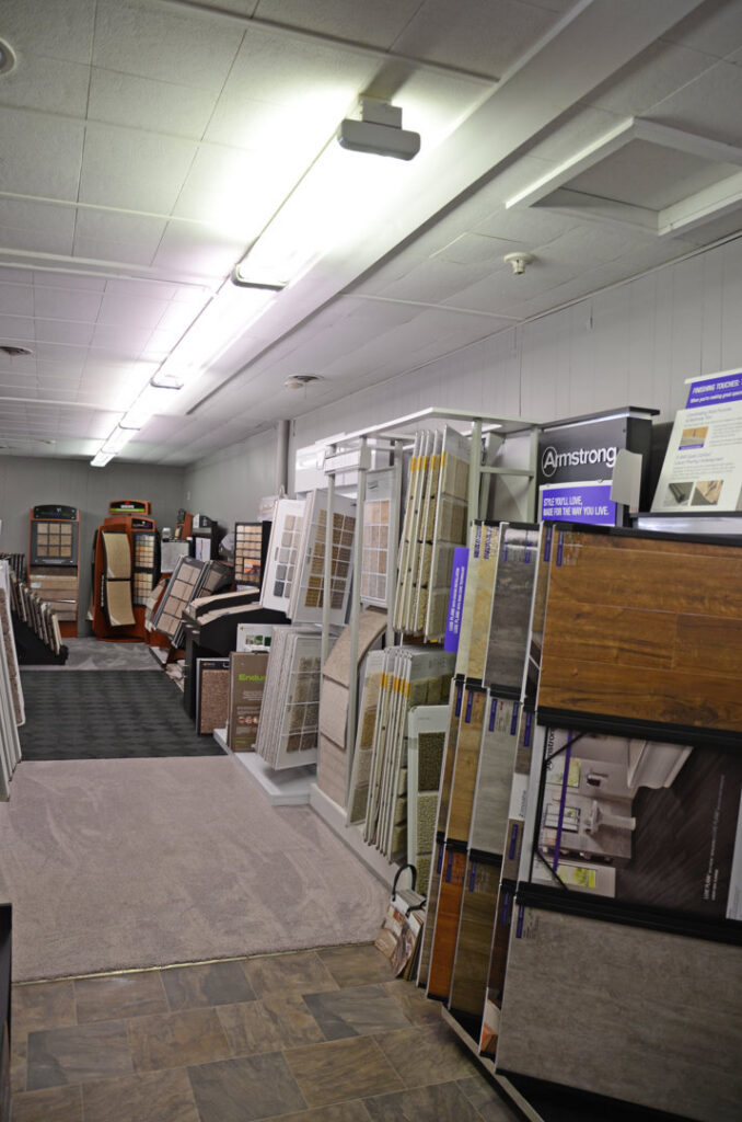 A carpeted aisle leading through the flooring showroom at BK The Floor Store of Nebraska in Columbus, NE.