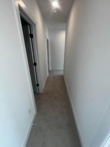 A carpeted hallway in a residential project completed by J3 Designs LLC in Wichita, KS
