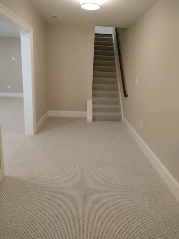 Carpeted hallway and stairs with new light-colored carpet installed by Amazonia Floors in bel air, Baldwin, MD.