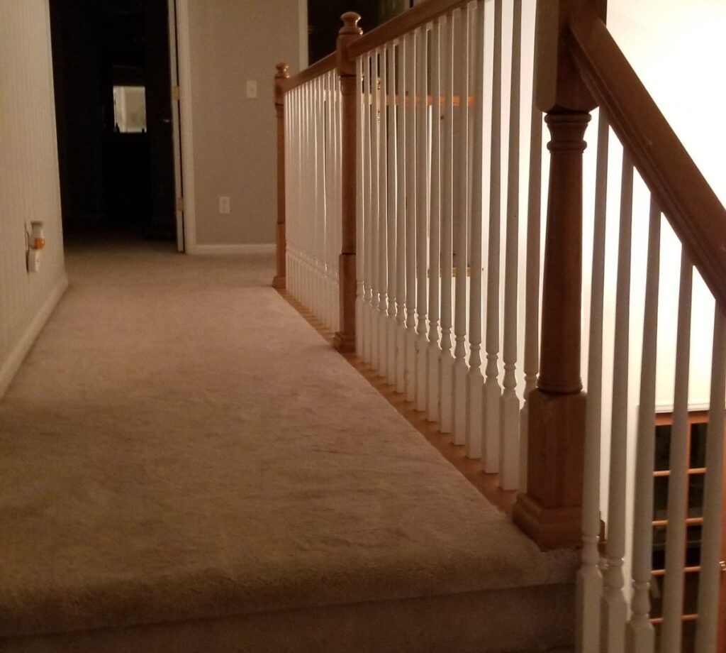 A newly carpeted hallway and stairs, demonstrating a professional carpet installation by Wagner Floors in Littleton, CO.