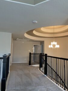 A carpeted hallway on an upper level of a home, showcasing a completed project by Castro's Carpet in Houston, TX.