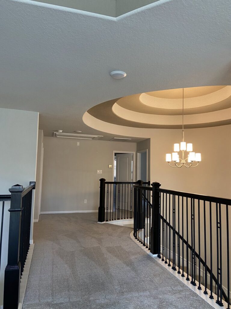 A carpeted hallway on an upper level of a home, showcasing a completed project by Castro's Carpet in Houston, TX.