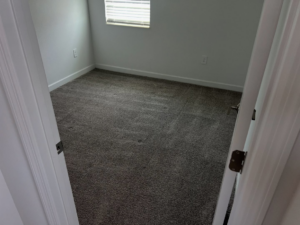 A carpeted room in a home, showing the current state before a carpet cleaning service by LSA mobile cleaning in Winter Garden, FL