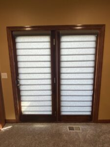 A room featuring a plush carpet installation and elegant French doors by Mozak's Floors & More in Yankton, SD