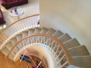 A beautifully carpeted spiral staircase installed by Dream Hardwood Floors, LLC in Bellevue, WA.