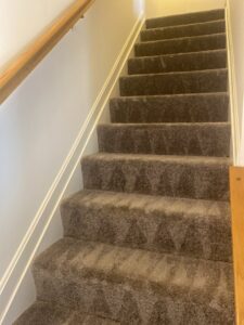A carpeted staircase showing fresh cleaning lines after professional service by USA Clean Master in Baltimore, MD