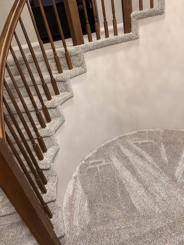 Overhead view of a beautifully carpeted staircase and landing by All about flooring utah in Salt Lake City, UT.
