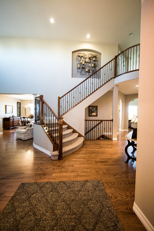 A beautifully carpeted staircase and a large area rug in a home, showcasing quality flooring by Kearney Flooring in Kearney, NE.