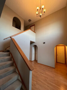 A carpeted staircase and entryway, demonstrating expert carpet installation by Ohio Pro Group in Columbus, OH.