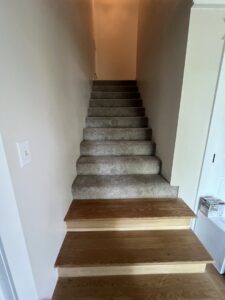 A newly installed light gray carpet on a residential staircase by BC Quality Flooring in Jeffersonville, IN.