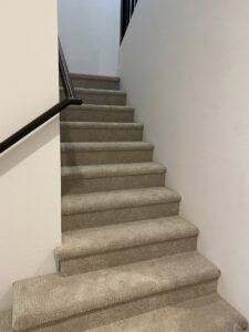 A newly carpeted staircase with grey carpet, expertly installed by Canyon State Flooring in Queen Creek, AZ.