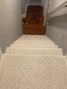 A newly installed patterned carpet on a staircase by Carolina Carpet, Hardwood & Tile in Mount Pleasant, SC