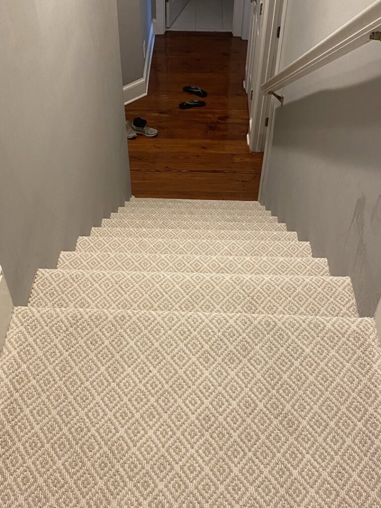 A newly installed patterned carpet on a staircase by Carolina Carpet, Hardwood & Tile in Mount Pleasant, SC