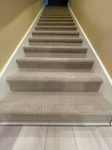 A newly installed carpeted staircase by C&P Flooring in Indianapolis, IN, showcasing quality carpet work.