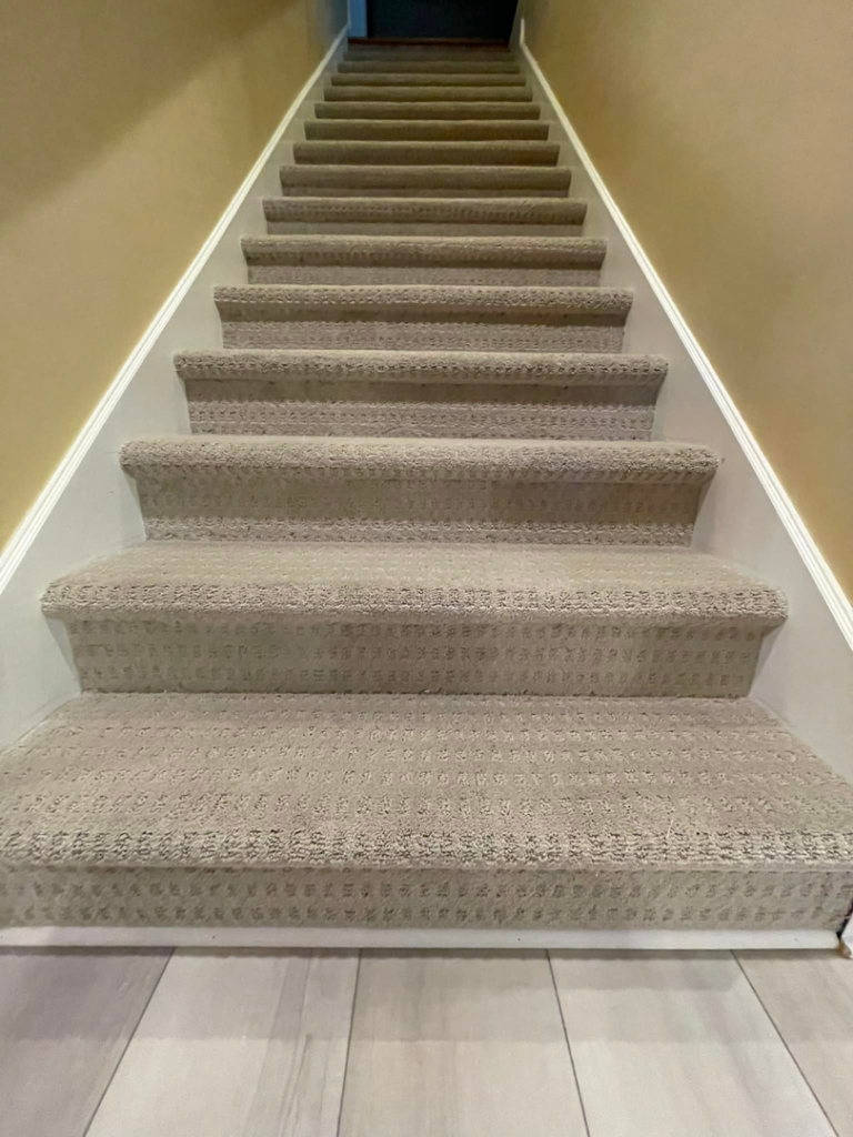 A newly installed carpeted staircase by C&P Flooring in Indianapolis, IN, showcasing quality carpet work.