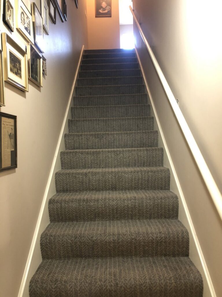 A newly installed carpet on a staircase, showcasing quality work by Hubbard Flooring Studio in Baton Rouge, LA.