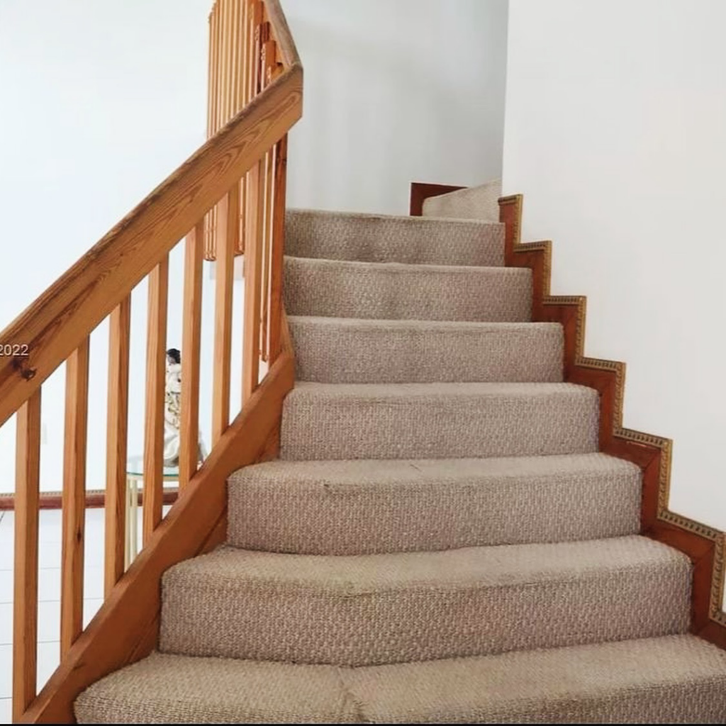 A newly carpeted staircase, showcasing professional carpet installation by NSJ Floor Supply in Hialeah, FL.