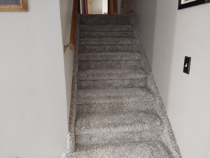 Newly installed light grey carpet on a staircase by Rendon Flooring in Green River, WY.