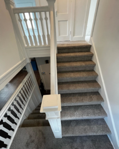 A newly carpeted staircase with grey carpet installed by Z Flooring in Noblesville, IN