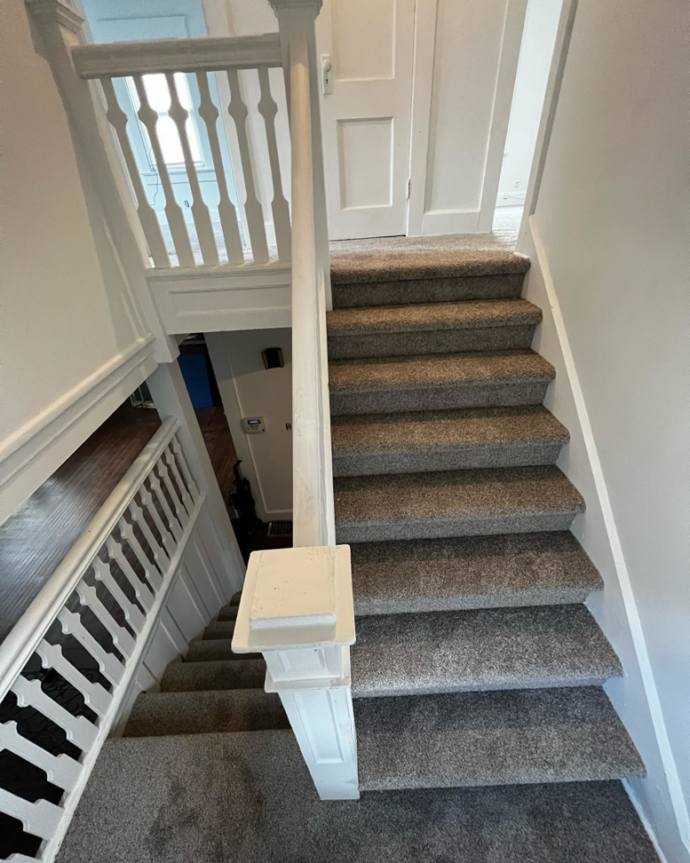 A newly carpeted staircase with grey carpet installed by Z Flooring in Noblesville, IN