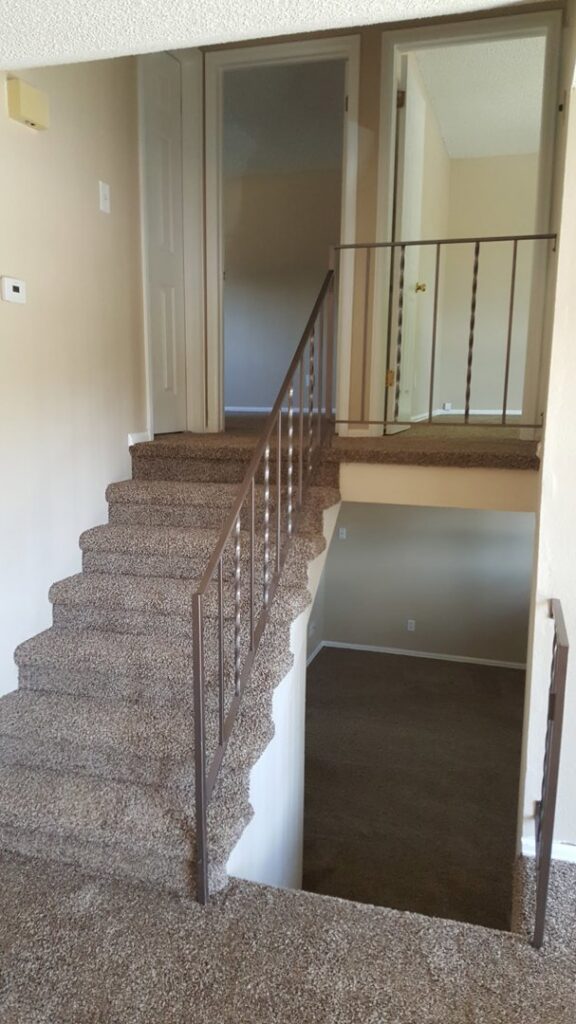 A multi-level home featuring a newly carpeted staircase and landing by Carpet Connection of Denver in Aurora, CO.