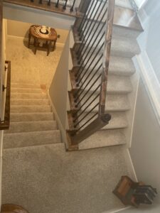 A newly carpeted staircase and landing area by Designer's Choice Flooring and Furniture in Lenexa, KS