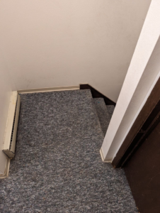 A view of a carpeted staircase, showcasing an area that Pristine Carpet Care LLC services in Longmont, CO.
