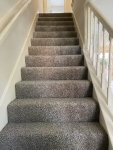 A neatly carpeted staircase in a residential home, installed by Castro's Carpet in Houston, TX.