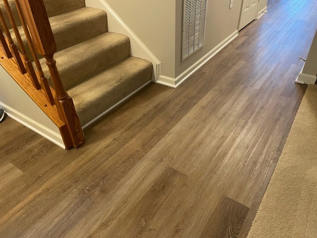 Carpeted stairs leading to a hallway with new flooring installed by Jordan's Flooring in Martinsburg, WV