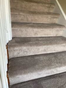 Carpeted stairs showing a clear before and after comparison of cleaning, demonstrating the work of HutchPro Carpet Cleaning Plus in Indianapolis, IN.