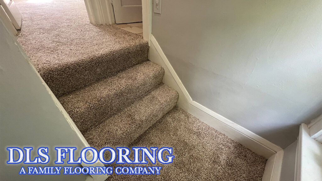 Newly installed speckled brown carpet on a residential staircase by DLS Flooring in Akron, OH.