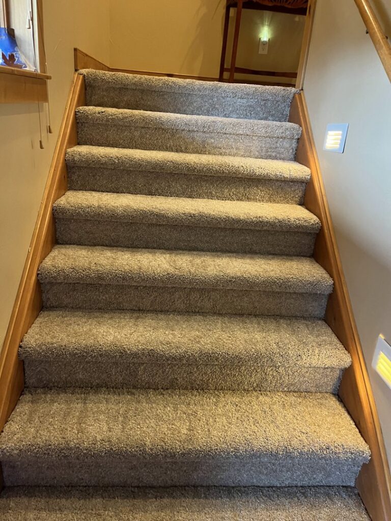 Newly installed carpet on a staircase by Pierce Carpet Mill Outlet in Bozeman, MT.