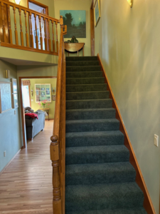 An upward view of a carpeted stairway, showcasing quality installation by Johnson Flooring in Newberg, OR.