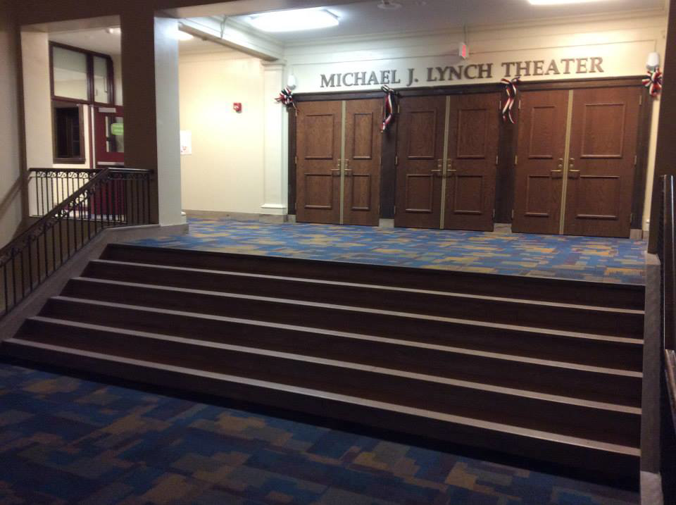 A beautifully carpeted theater entrance and stairs, showcasing a completed project by Flooring Authority, Inc. in Amsterdam, NY.