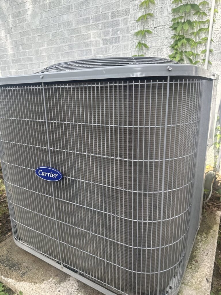 A close-up view of a Carrier outdoor AC unit, ready for service by Summit Service Group in North Little Rock, AR.
