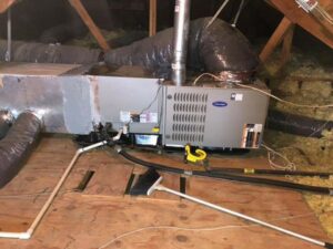 A Carrier furnace and air handler unit with ductwork installed in an attic by Griffin's Heating & Air in Tulsa, OK.