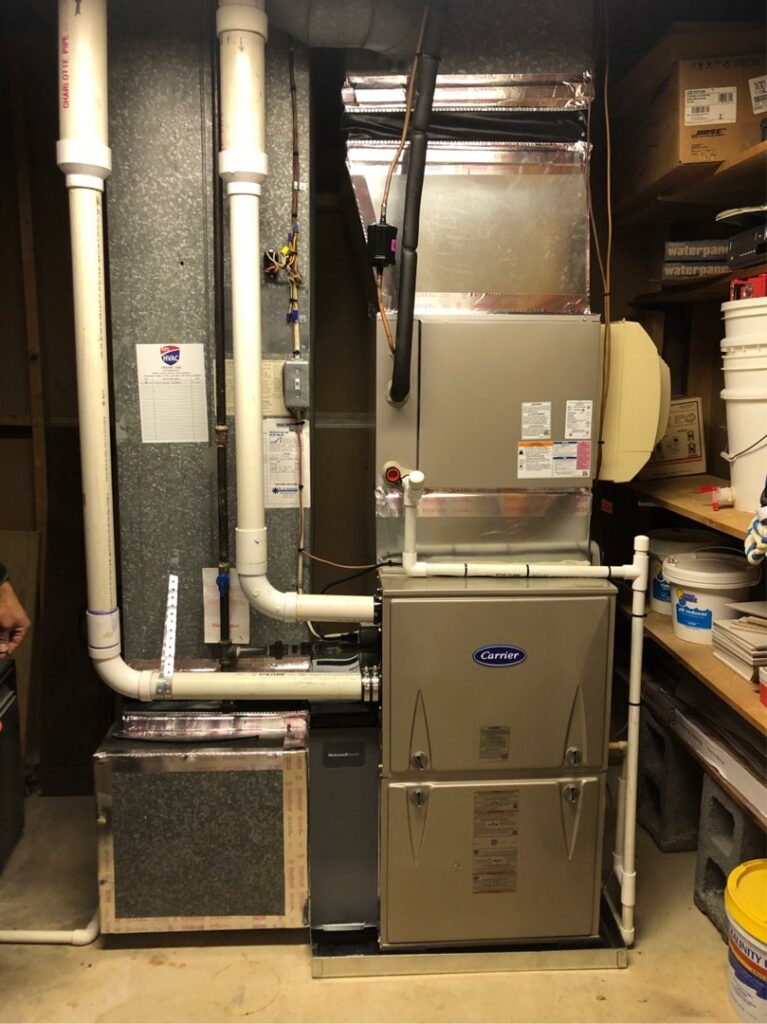 A Carrier furnace and air handler unit with connected ductwork, installed by 495 HVAC in Annandale, VA.