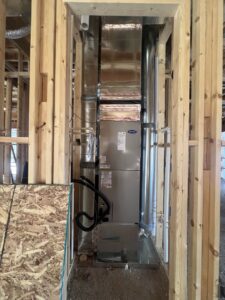 A Carrier furnace and air handler unit installed within the framing of a new construction home by Vanessa Service HVAC in Falls Church, VA.