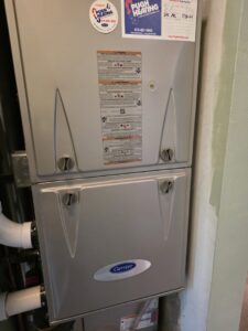 A close-up of a Carrier furnace and air handler unit installed by Pugh Heating & Air Conditioning in Holland, OH.