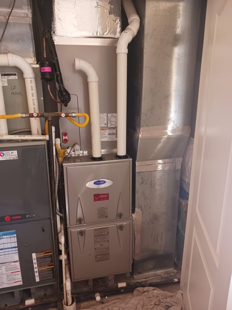 A Carrier furnace and associated ductwork installed in a utility area by MMI Climate Solutions in Lexington, KY.