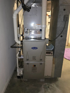 A Carrier furnace and air handler system with a Honeywell thermostat, installed by Temperature Comfort Heating and Cooling in Louisville, KY.