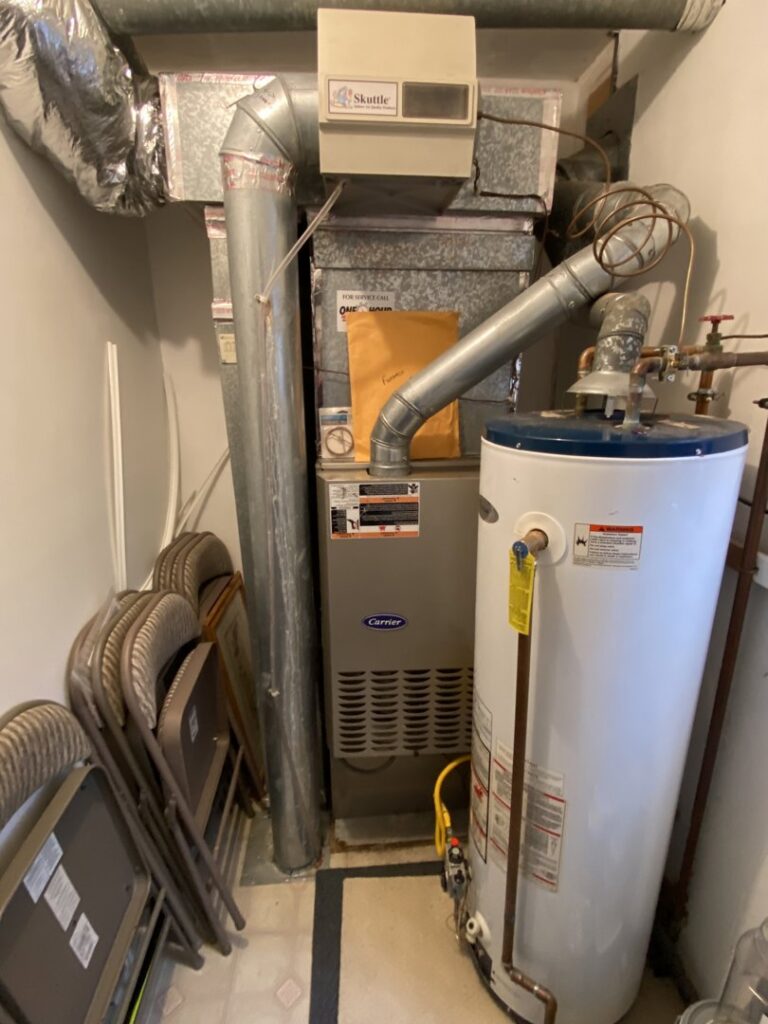 A Carrier furnace and water heater installed in a utility space by Air We Are in Toms River, NJ.