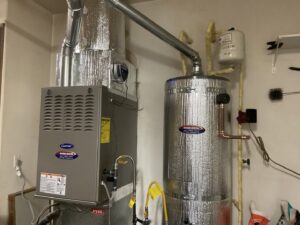An indoor Carrier furnace and water heater installation with ductwork by Nevada Heating Reno in Sparks, NV.